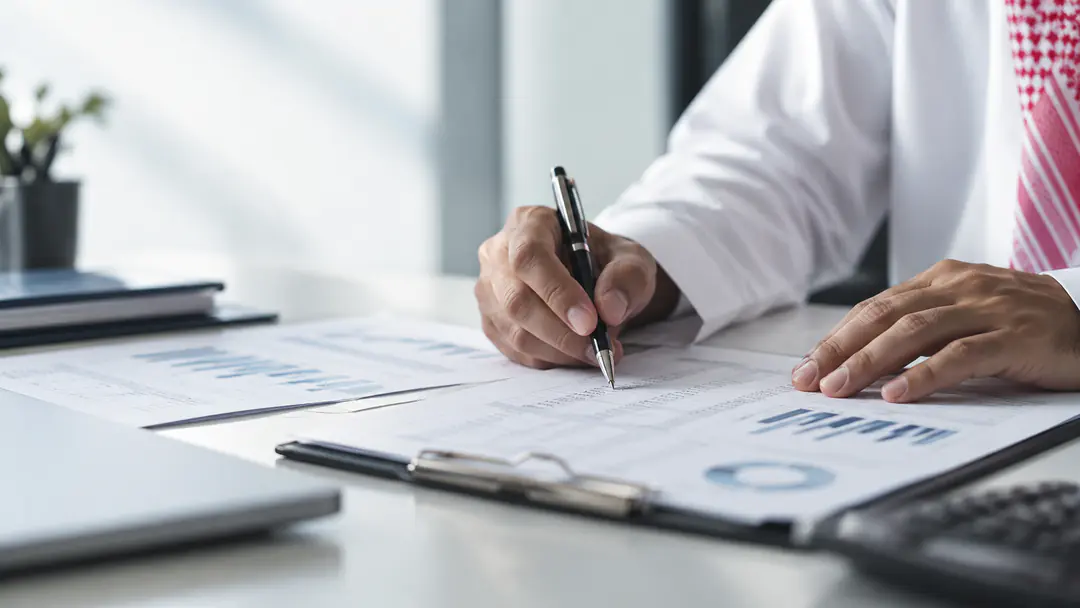 Hands reviewing financial and audit documents